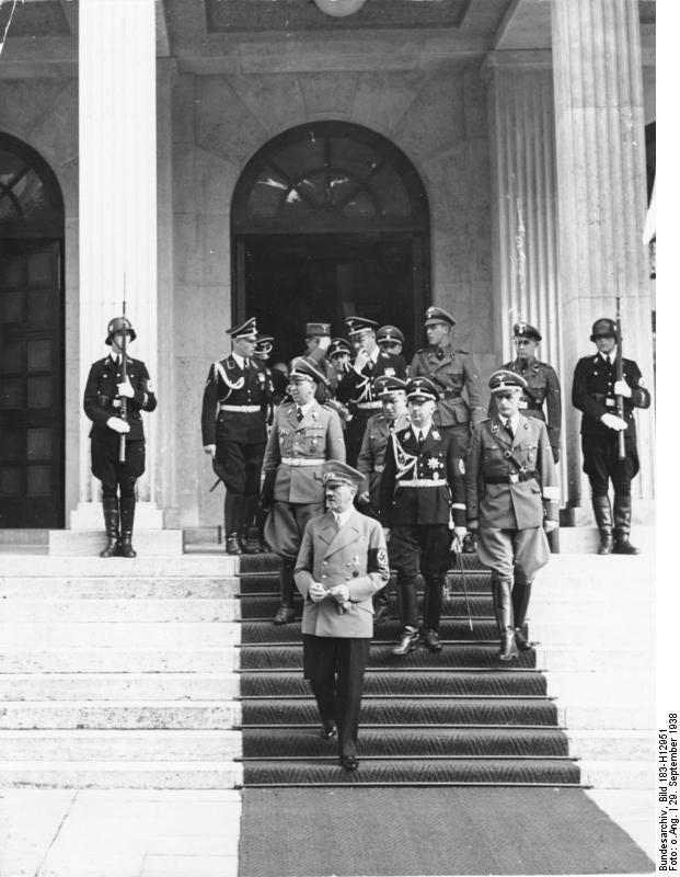 Adolf Hitler leaves the Führerbau in Munich for a pause during the negotiations